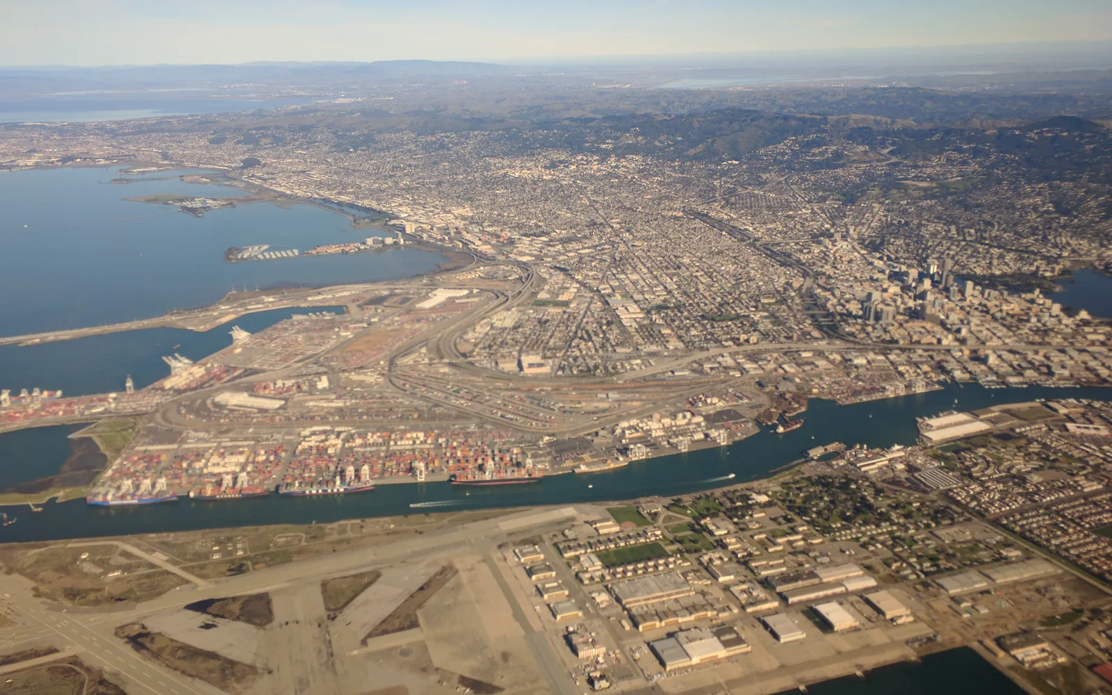Port of Oakland container terminal with cargo cranes and railway infrastructure
