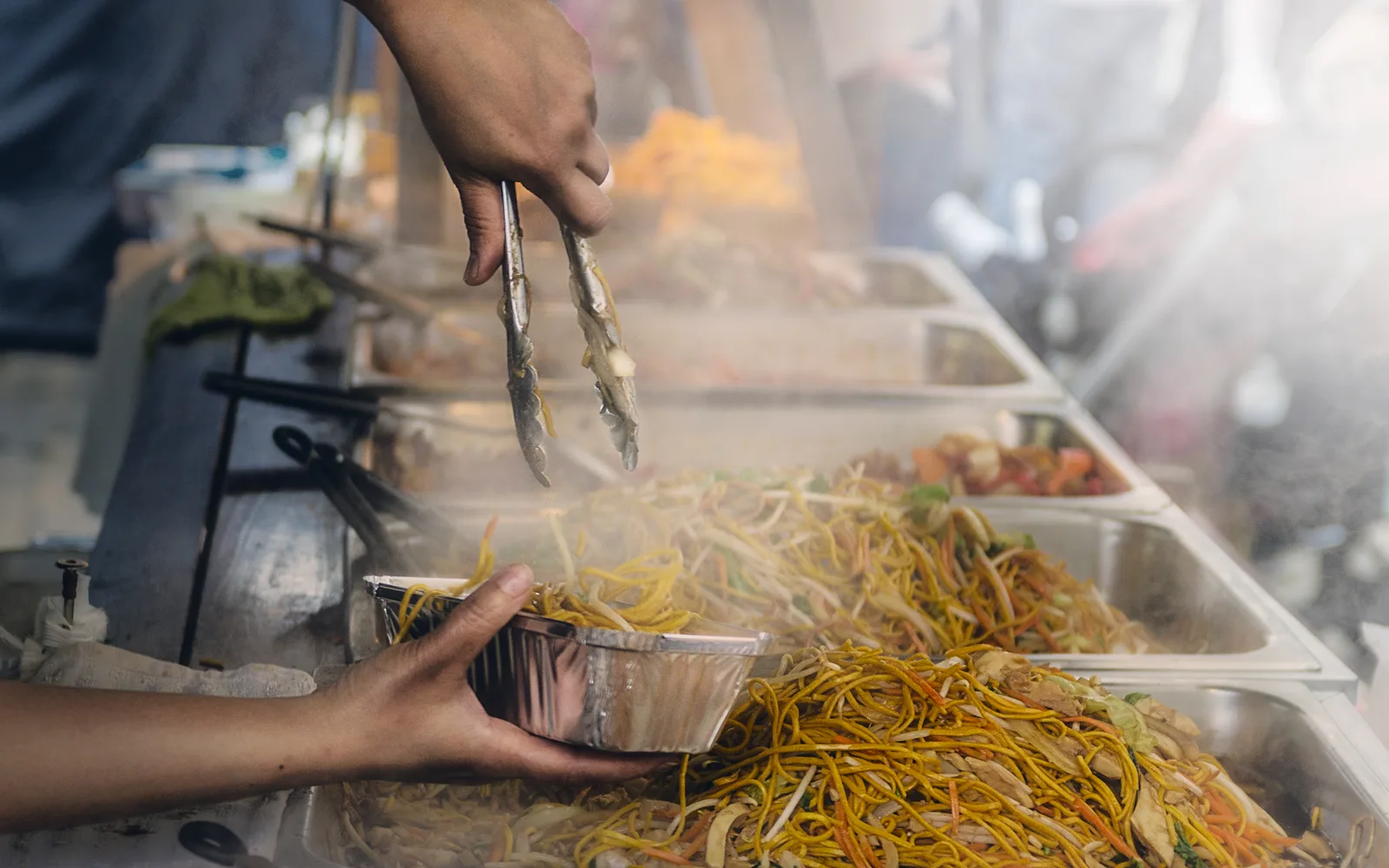 Street food vendor preparing diverse culinary offerings
